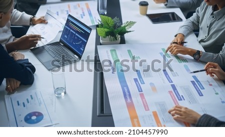 Multi-Ethnic Office Conference Room Businesspeople Meeting at Big Table. Diverse Team of Creative Entrepreneurs Talk, Find Solution. Specialists work in Digital e-Commerce Startup. Focus on Hands Royalty-Free Stock Photo #2104457990
