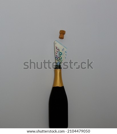 20 Euro notes blowing the cork off a champagne bottle as they burst out. The concept of a celebration. Royalty-Free Stock Photo #2104479050