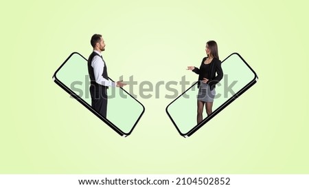 Collage of man and woman, employees sticking out phone screen and talking isolated over green background. Having onlin conference. Concept of business, online communication, cooperation and ad