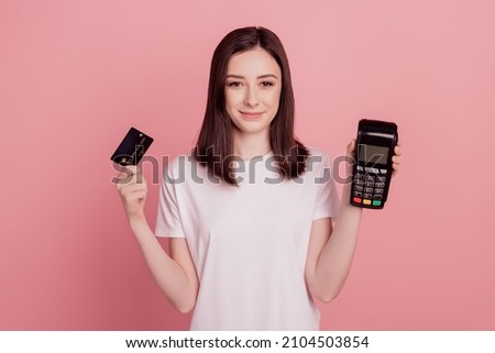 Photo of young pretty girl hold credit card atm terminal cashless pay shop buy isolated over pink color background