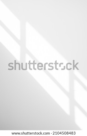 Natural Light and shadow from window overlay effect on  white background. Silhouette light abstract can use for wallpaper minimal,mock up design.Black and white blurred image backdrop. Royalty-Free Stock Photo #2104508483