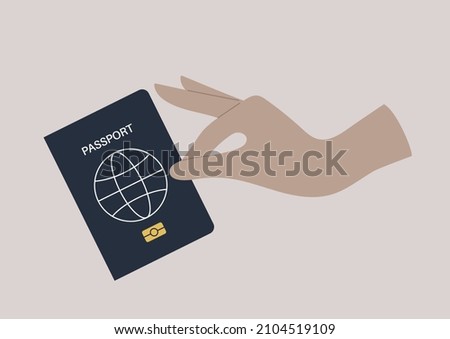 A hand holding a passport cover, a citizenship ID document