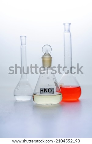 Photo Laboratory glass flasks with multicolored liquid isolated on white