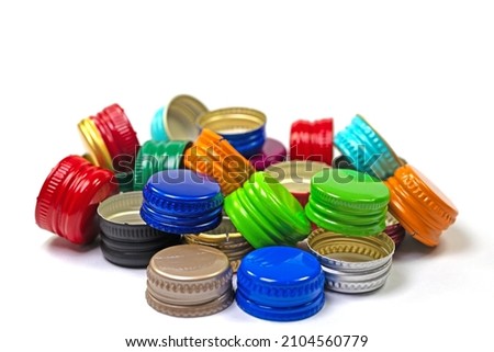 Old tinplate bottle caps against a white background Royalty-Free Stock Photo #2104560779