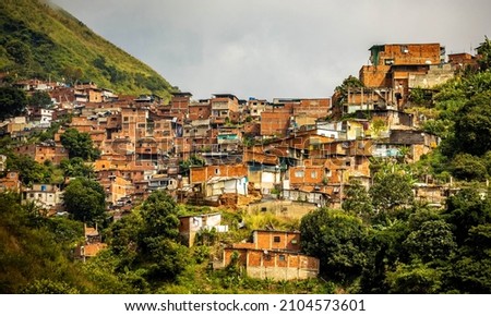 Urban residential buildings on hill in Caracas Venezuela capital at day Royalty-Free Stock Photo #2104573601