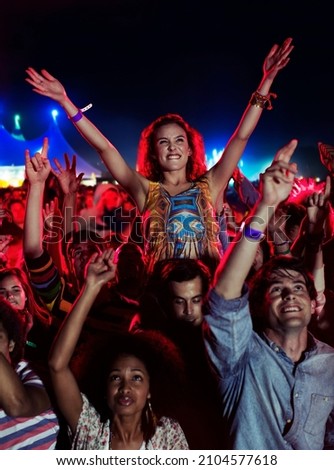 Fans cheering at music festival Royalty-Free Stock Photo #2104577618