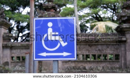 Handiccaped or wheelchair reserved parking lot sign 