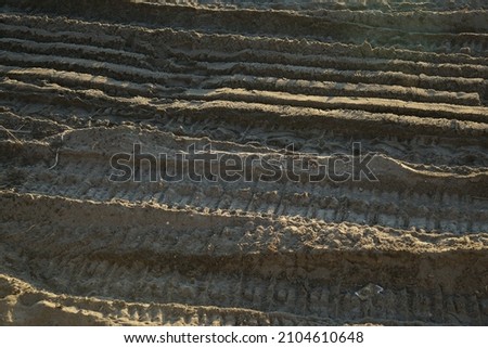 Footprints on the sand of the bulldozer tracks, imprinted for beach nourishment after repeated storm surges.