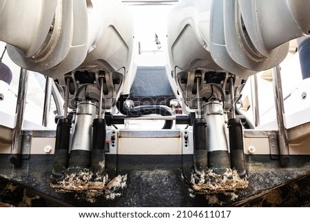 Lifting mechanisms on outboard motors at the stern of the boat. Transom lift on outboard motors of a motor boat. Royalty-Free Stock Photo #2104611017