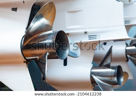 Motor propellers for motor yachts and boats close-up. The motors are mounted at the stern of the motor boat. Repair a boat in a dry dock. Royalty-Free Stock Photo #2104612238