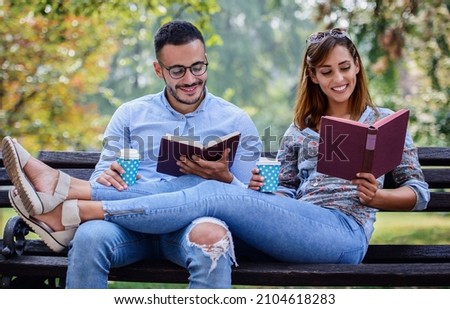 Campus life, student's love. Young couple learning together in the park. Education, love and tenderness, dating, romance, lifestyle concept Royalty-Free Stock Photo #2104618283