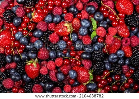 Various fresh summer berries backgrounds. Strawberry, blueberry, raspberry red currant and blackberry mix. Top view, flat lay. Royalty-Free Stock Photo #2104638782