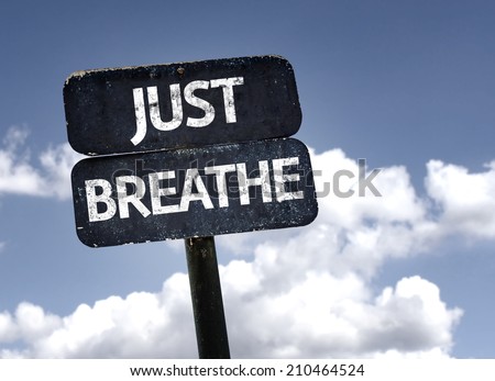Just Breathe sign with clouds and sky background 