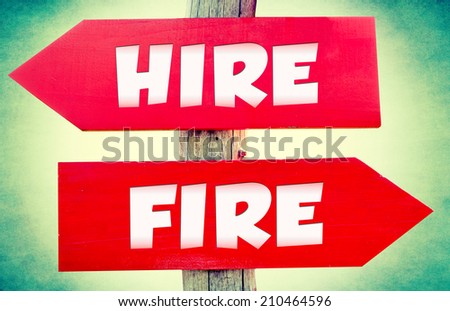 Hire and fire concept on the red signs with landscape in background