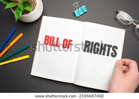 BILL OF RIGHTS text on the notebook with businessman's hands