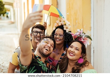 Brazilian Carnival. Group of friends taking a self portrait Royalty-Free Stock Photo #2104708211