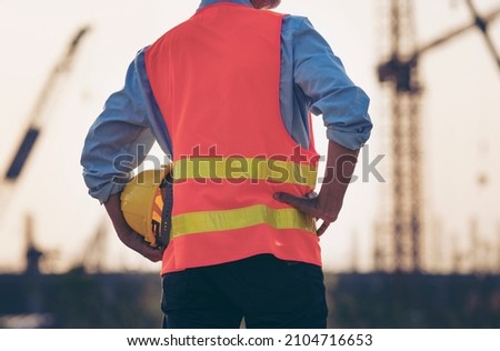 Surveyor Large building Engineer technician  Business Team discuss plan at construction site. Road construction machinery on the construction of highway. High ground heavy industry and safety concept.
