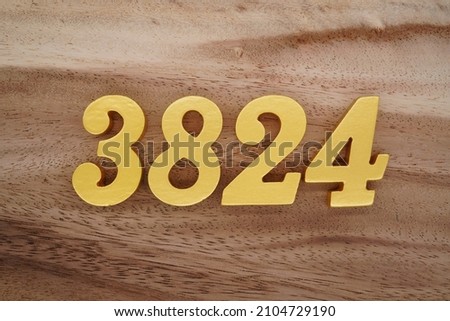 Golden Arabic numerals 3824 on a dark brown to white wood grain background.