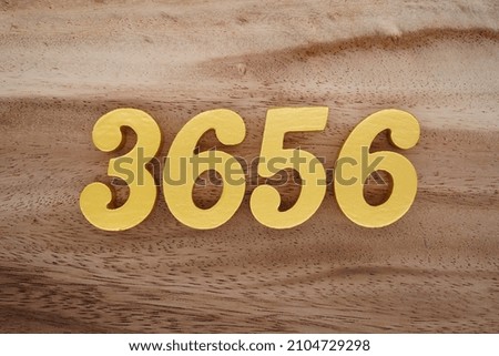 Golden Arabic numerals 3656 on a dark brown to white wood grain background.