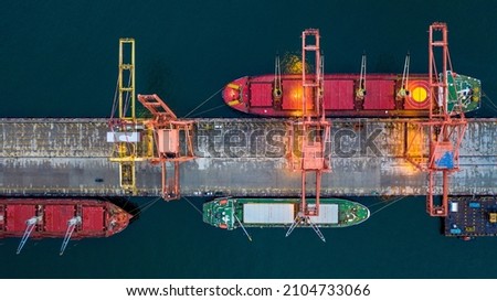 Aerial view bulk carrier dock, Global business import export logistic and transportation company, Commercial dock container cargo vessel freight shipping worldwide. Royalty-Free Stock Photo #2104733066