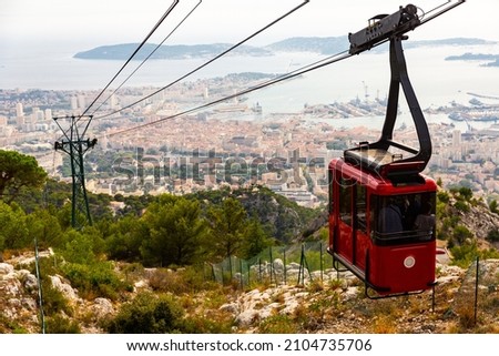 View of French city Toulon from Mount Faron. Cable car to mount in foreground. Royalty-Free Stock Photo #2104735706