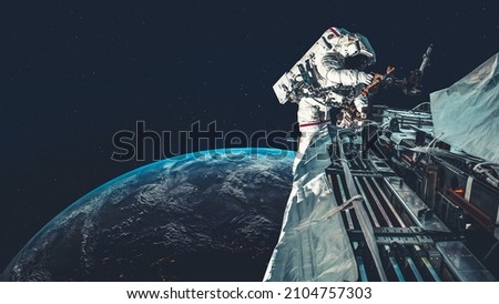 Astronaut spaceman do spacewalk while working for spaceflight mission at space station . Astronaut wear full spacesuit for operation . Elements of this image furnished by NASA space astronaut photos . Royalty-Free Stock Photo #2104757303