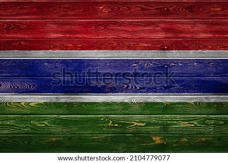 The national flag of Gambia
 is painted on a camp of even boards nailed with a nail. The symbol of the country.
