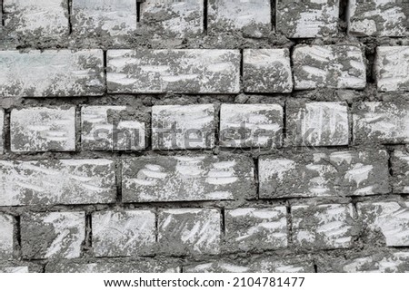 Brick wall in concrete as a background. Black and white photo