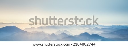 Majestic sunset in the mountains.The natural light of the sun fell on the horizon. Natural background Royalty-Free Stock Photo #2104802744