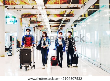Thermoscan or thermal camera infrared simulation for check body temperature scan travel passenger fever in quarantine for coronavirus omicron wearing safety mask at International terminal airport