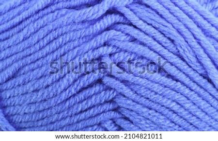 Blue knitting wool close-up.Blue yarn clew close up texture. Blue wool background.