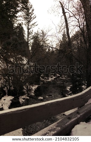 Photo on a bridge around snow and water in the canyon.