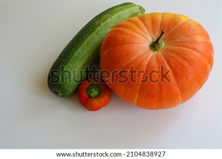 Pumpkin, zucchini, mini pepper. Composition from vegetables on a white background. There is a place for an inscription.