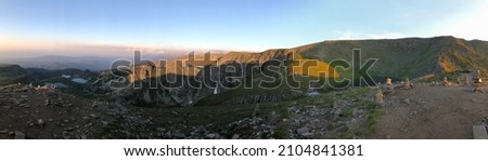 Panoramic mountain landscape with lakes and rocks at sunset. Mobile photography