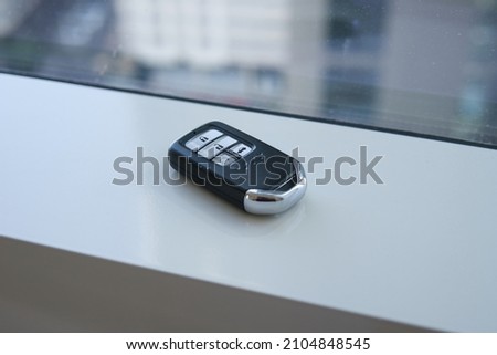 A car key at the window
