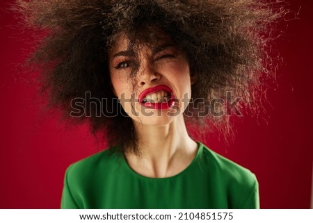 Pretty young female Afro hairstyle green dress emotions close-up studio model unaltered
