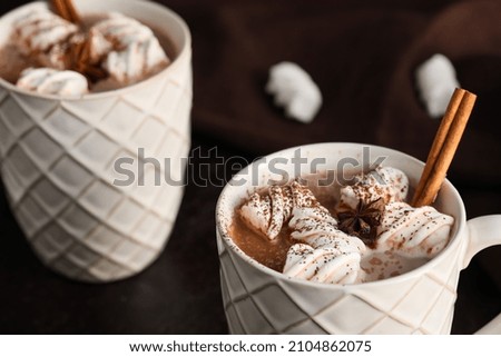 Cups of hot coffee with marshmallows on dark background, closeup
