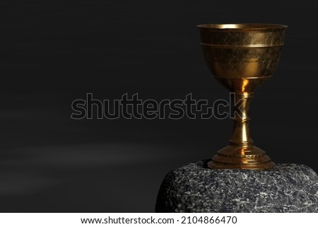 Old chalice on stone and grey background.  Royalty-Free Stock Photo #2104866470