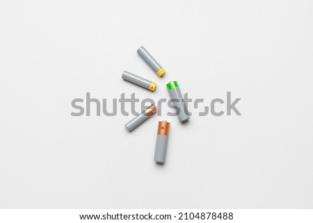 Alkaline batteries on white background, top view Royalty-Free Stock Photo #2104878488
