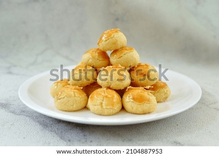 Nastar Cookies, Pineapple tarts or nanas tart are small, bite-size pastries filled or topped with pineapple jam, commonly found when Hari Raya or Eid Al Fitr or Lebaran. Selective focus. Royalty-Free Stock Photo #2104887953