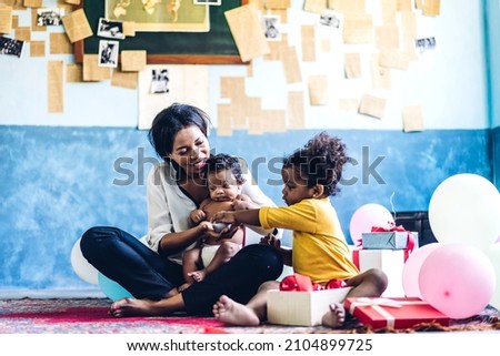 Portrait of enjoy happy love family african american mother play with adorable little african american baby.Mom touching with cute girl moments good time in a white bedroom.Love of black family