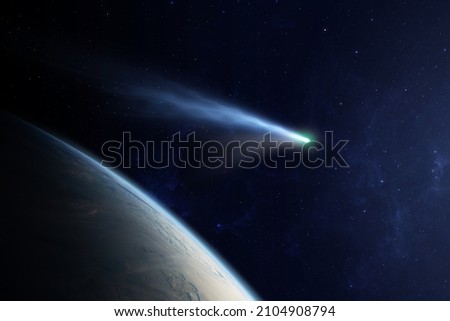 Сomet flying close to planet Earth. Comet flying through space close to the Earth planet. The concept of the apocalypse, armageddon, doomsday. Elements of this image furnished by NASA. Royalty-Free Stock Photo #2104908794
