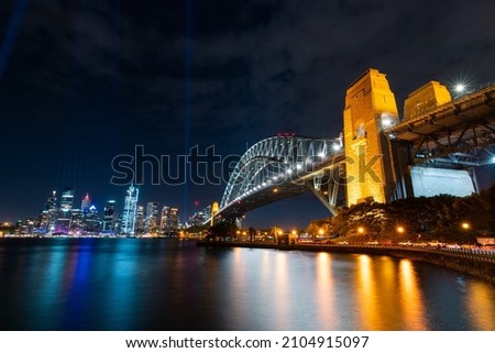 Night view of Sydney Harbour Bridge with cityscape.