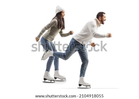 Full length profile shot of a casual man and woman ice skating isolated on white background