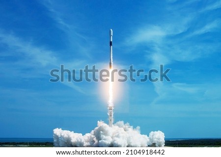 Take off space rocket on a background of blue sky and sun. Elements of this image were furnished by NASA. High quality photo