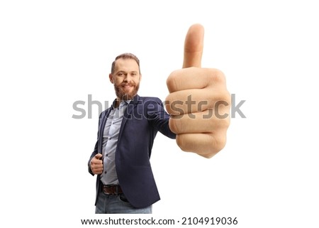 Smiling beared man gesturing a thumb up sign in front of camera isolated on white background