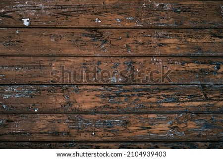 Old brown painted rustic wooden wall background, blank notice plank with old oxidized staples and thumbtacks, grunge texture  Royalty-Free Stock Photo #2104939403