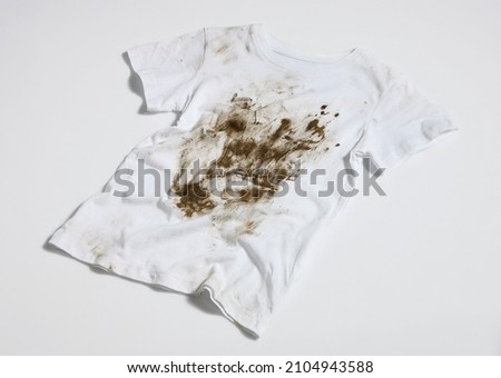 muddy and dirty white t-shirt Royalty-Free Stock Photo #2104943588