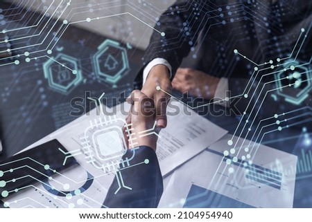 Handshake of two businesswomen who enters into the contract to develop a new software to improve business service at a company. Technological icons over the table with the document.