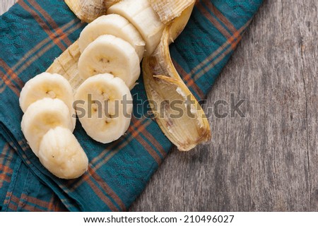 Sliced ripe banana on wood table.